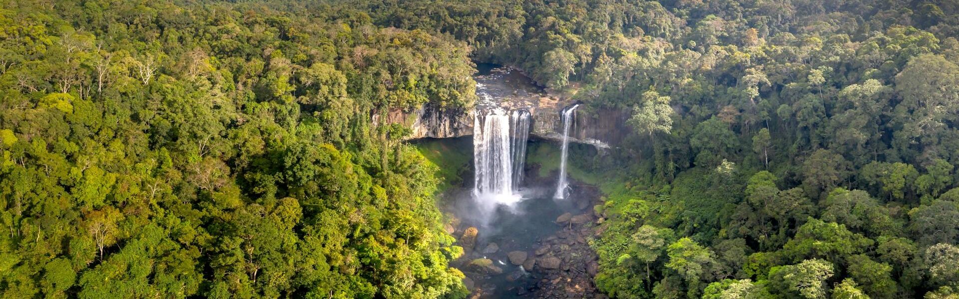 Champasak’s serene Mekong scenery in Laos on a Champasak Travel banner by Legend Travel Group.